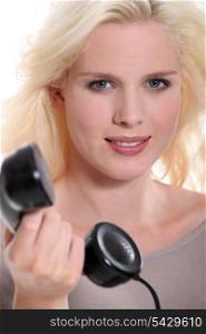 Blond woman with old telephone handset