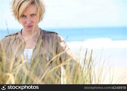 Blond woman with serious expression at the beach