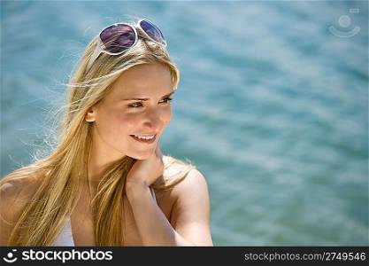 Blond woman with sunglasses at sea