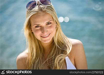 Blond woman with sunglasses with sunglasses at sea