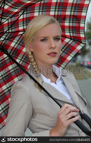 Blond woman with tartan umbrella