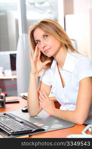 Blond woman working in the office