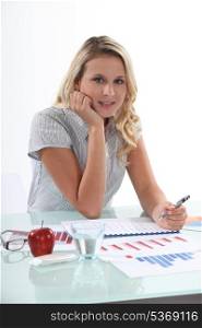 Blond woman working with financial graphs