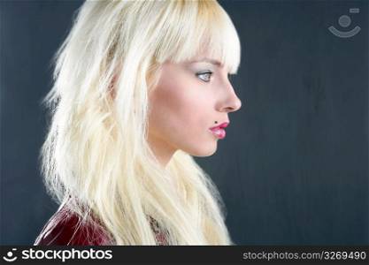 blond young girl profile portrait over gray background