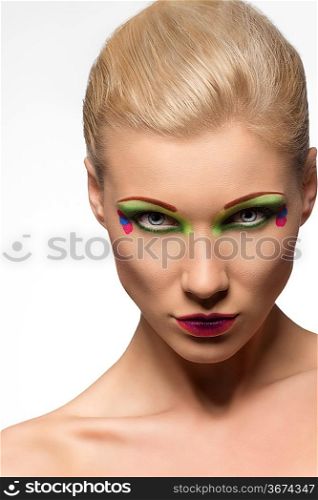 blonde beauty girl with color make-up, looking in camera with endearing expression