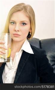 Blonde business woman holding a glass of water