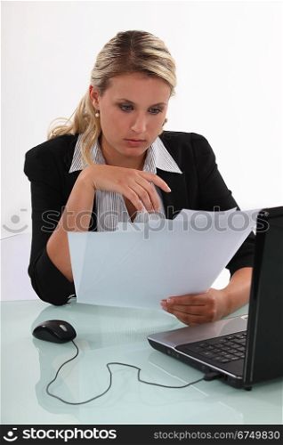 blonde businesswoman going through files