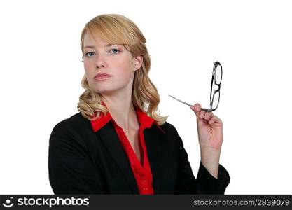 blonde businesswoman holding her head high up with glasses
