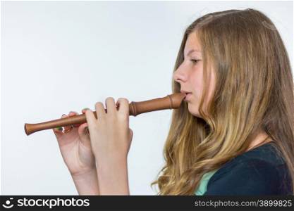 Blonde caucasian teenage girl with long blonde hair playing the flute isolated on white background
