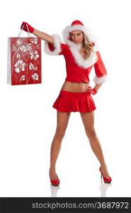 blonde christmas girl dressed as santa claus with a red mini skirt and jacket with fur holding a gift bag