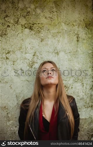 Blonde fashion girl on a vintage wall