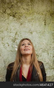 Blonde fashion girl on a vintage wall