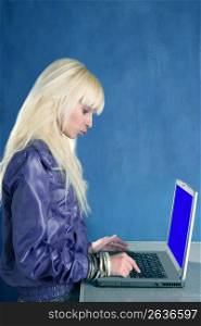 blonde fashion student laptop blue background