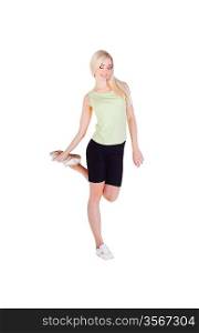 blonde girl doing her exercise on one leg and smiling on white background