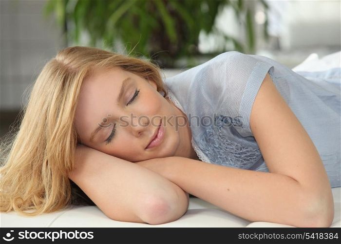 Blonde girl napping on couch
