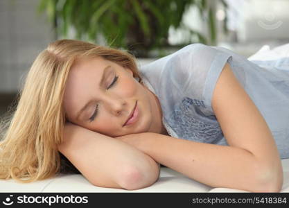 Blonde girl napping on couch