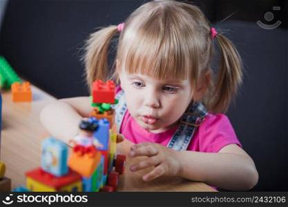 blonde girl playing with toy train