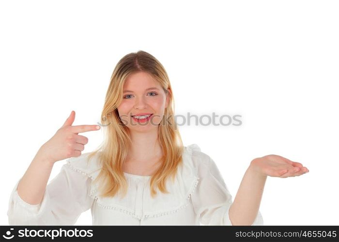 Blonde girl pointing something with the finger isolated on a white background
