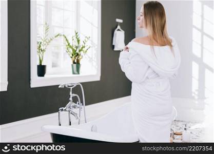 blonde girl posing bathroom with bath robe