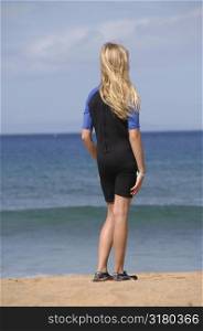 Blonde girl standing on the beach