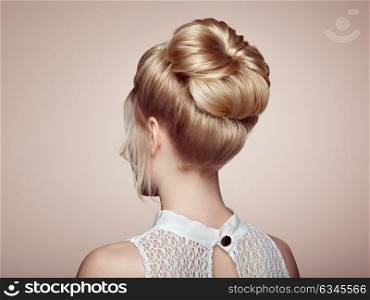 Blonde Girl with Elegant and shiny Hairstyle. Beautiful Model Woman with Curly Hairstyle. Care and Beauty Hair products. Care and Beauty of Hair