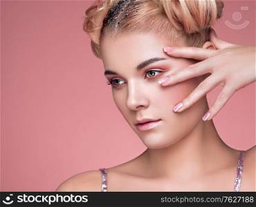 Blonde Girl with Elegant and shiny Hairstyle. Beautiful Model Woman with Curly Hairstyle. Care and Beauty Hair products. Nails and Manicure. Hair Curled into a Bun