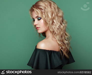 Blonde girl with long and shiny curly hair. Blonde Girl with Long and shiny Curly Hair. Beautiful Model Woman with Curly Hairstyle. Care and Beauty Hair products. Perfect Make-Up