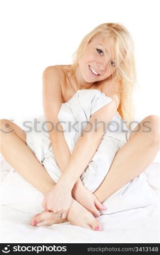 Blonde girl with pillow on the bed