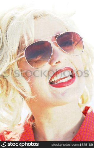 Blonde haired young woman with sunglasses on retro style