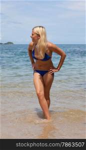 blonde in a bathing suit having fun on the beach. Sea, islands.