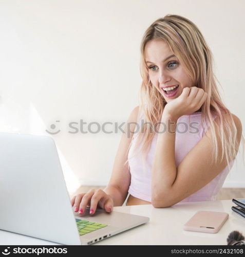 blonde influencer using laptop