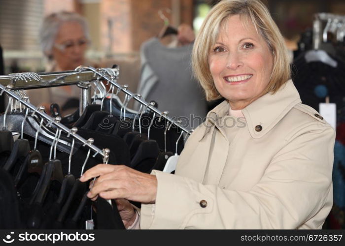 blonde lady doing shopping in a clothes shop