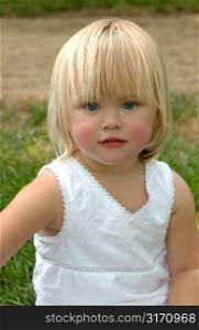 Blonde Little Girl in Grassy Field