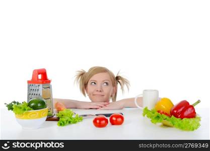 blonde looks for fresh vegetables. Isolated on white background