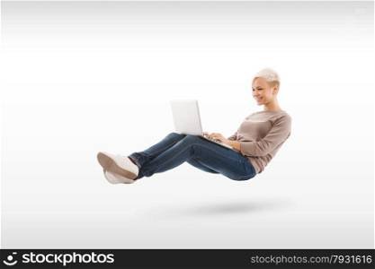 Blonde relaxed woman with notebook on her legs over white isolated background