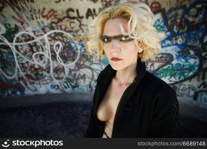 Blonde science fiction model in front of grafitti