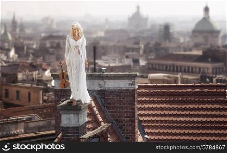Blonde standing on the dirty chimney with the violin