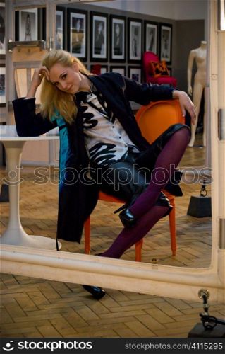 Blonde strikes a pose in mirror, reflection