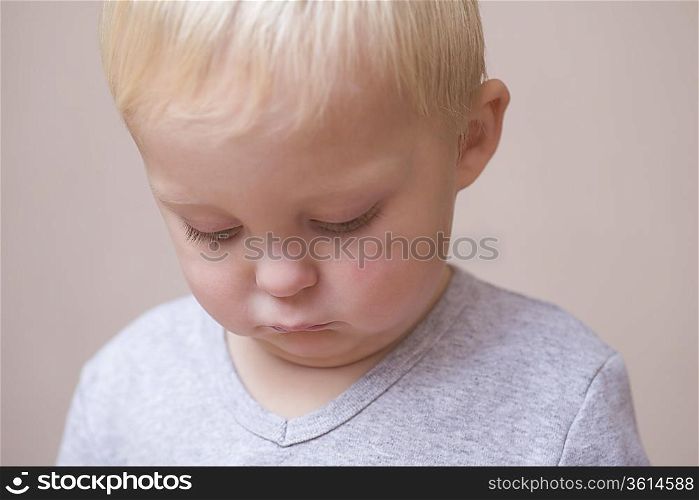 Blonde toddler looking unhappy