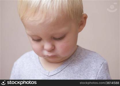 Blonde toddler looking unhappy