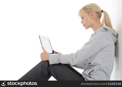 Blonde with a computer on his lap. Isolated on white background