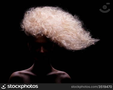 blonde with creative hairstyle, studio shot, over black