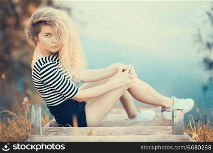 blonde with curly hair / beautiful girl model with long curly hair, natural beauty concept