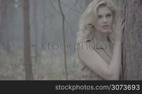 blonde woman alone in the forest