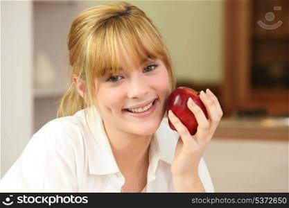 Blonde woman and an apple