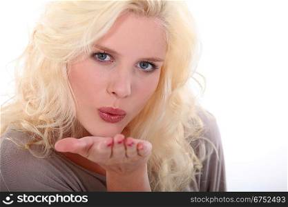 Blonde woman blowing kiss