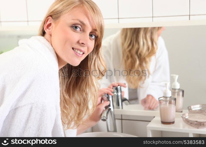 Blonde woman dressed in bathrobe