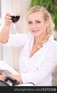blonde woman drinking red wine