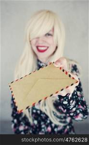 Blonde woman holding retro paper envelopes
