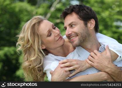 Blonde woman hugging man